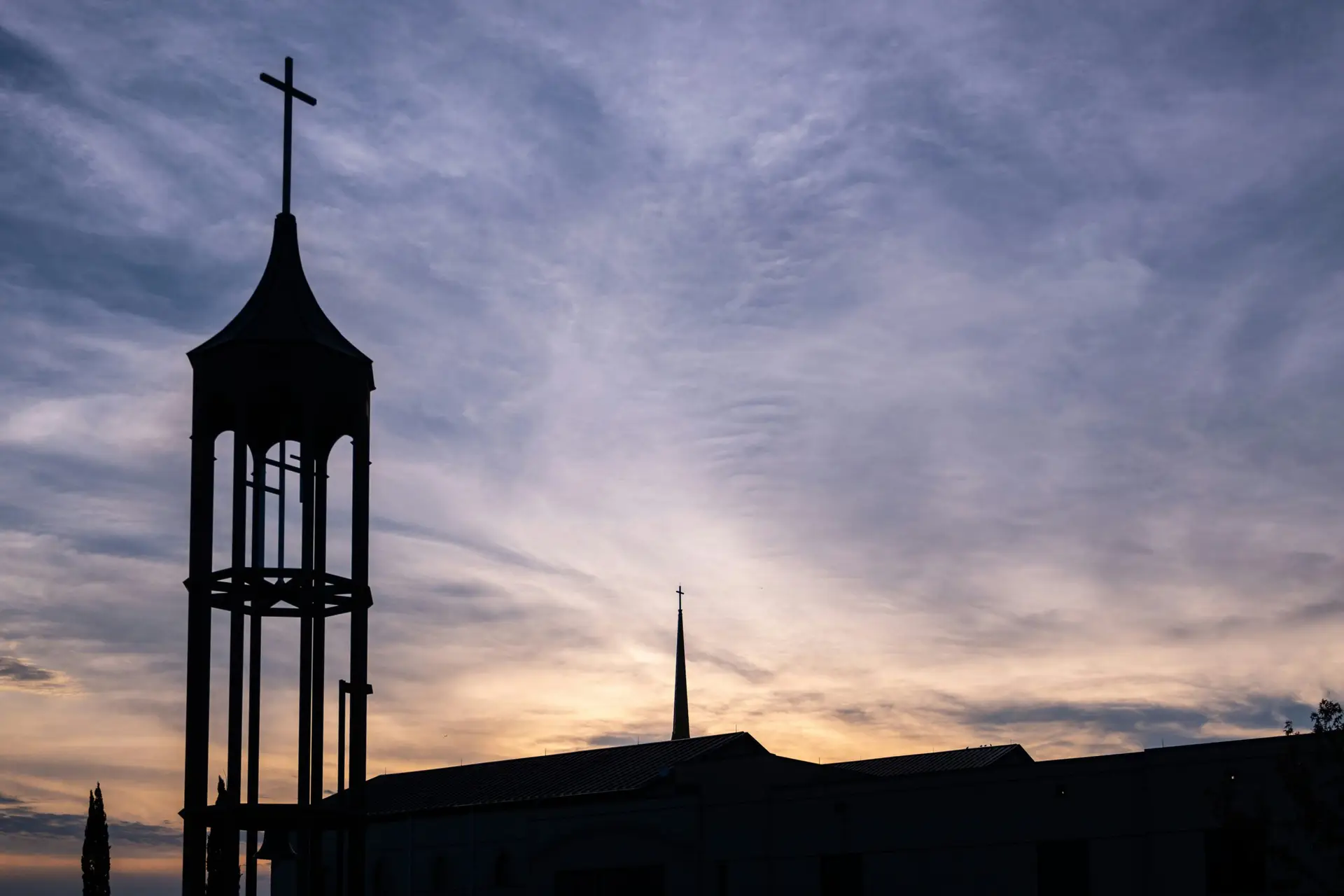 a tall tower with a cross on top of it